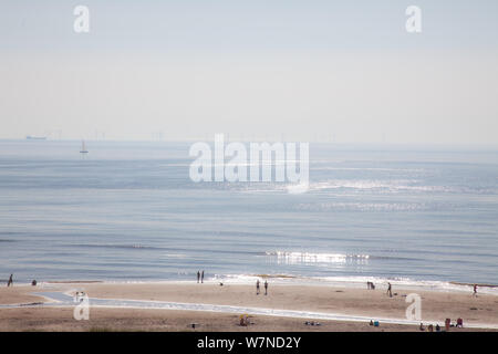 Egmond aan Zee, Netherlands - bathing people on the beach in the glistening sun (high key exposure) Stock Photo