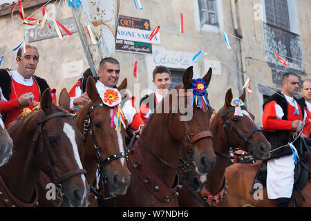 Traditionally dressed riders parading during the Madonna dei Martiri festival, in Fonni, Nuoro district, Sardinia, Italy. Stock Photo