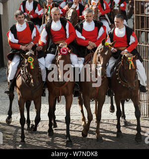 Traditionally dressed riders parading during the Madonna dei Martiri festival, in Fonni, Nuoro district, Sardinia, Italy. Stock Photo