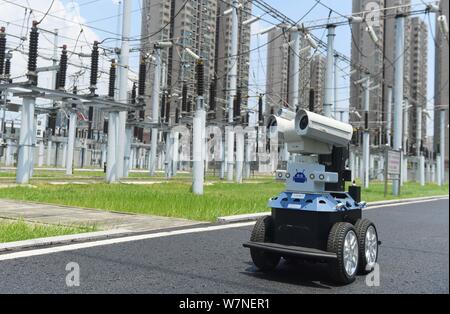 A robot is pictured as it is used to help Chinese workers check the substation during the scorching days at a power transformer substation in Chuzhou Stock Photo