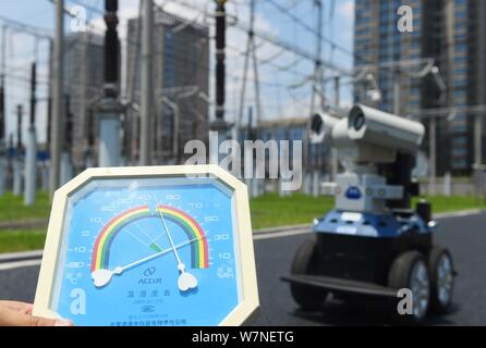 A robot is pictured as it is used to help Chinese workers check the substation during the scorching days at a power transformer substation in Chuzhou Stock Photo