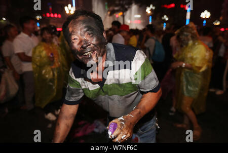 People of Yi ethnical minority gather to celebrate the 'black face' festival in Kunming city, southwest China's Yunnan province, 17 July 2017.   Touri Stock Photo