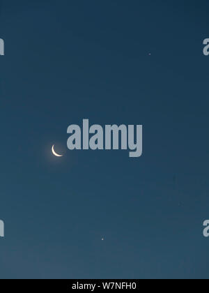 The Moon (waning crescent) with Venus (below) and Jupiter (above) as seen just before sunrise on the morning of 15 July 2012 from Aurora, Colorado, USA Stock Photo