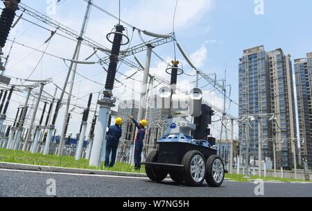 A robot is pictured as it is used to help Chinese workers check the substation during the scorching days at a power transformer substation in Chuzhou Stock Photo