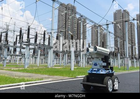 A robot is pictured as it is used to help Chinese workers check the substation during the scorching days at a power transformer substation in Chuzhou Stock Photo