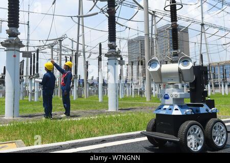 A robot is pictured as it is used to help Chinese workers check the substation during the scorching days at a power transformer substation in Chuzhou Stock Photo