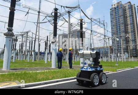 A robot is pictured as it is used to help Chinese workers check the substation during the scorching days at a power transformer substation in Chuzhou Stock Photo