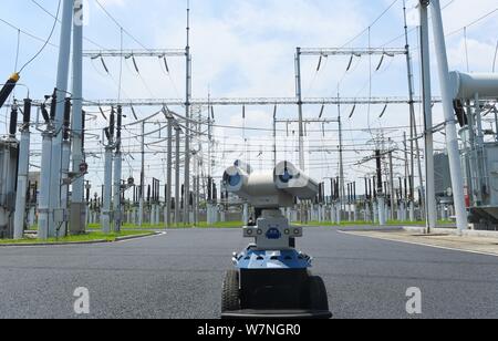 A robot is pictured as it is used to help Chinese workers check the substation during the scorching days at a power transformer substation in Chuzhou Stock Photo