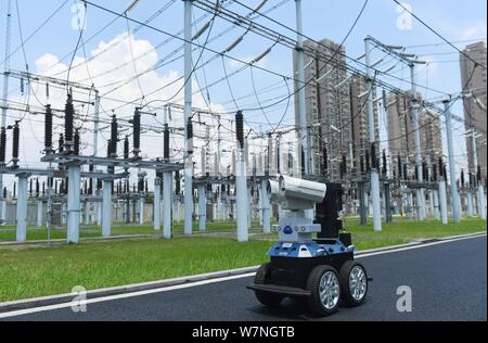 A robot is pictured as it is used to help Chinese workers check the substation during the scorching days at a power transformer substation in Chuzhou Stock Photo