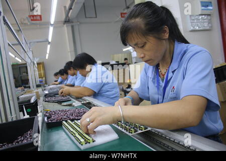 --FILE--Female Chinese workers produce electronic products on the ...