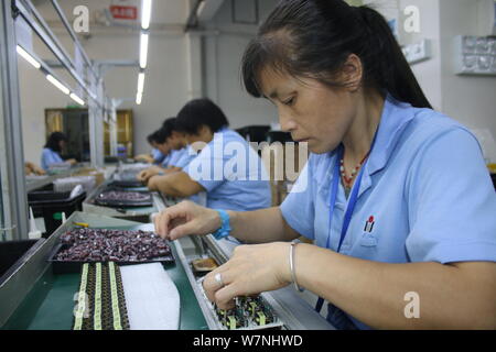 --FILE--Female Chinese workers produce electronic products on the ...