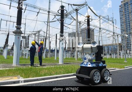 A robot is pictured as it is used to help Chinese workers check the substation during the scorching days at a power transformer substation in Chuzhou Stock Photo