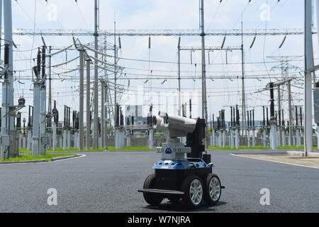 A robot is pictured as it is used to help Chinese workers check the substation during the scorching days at a power transformer substation in Chuzhou Stock Photo