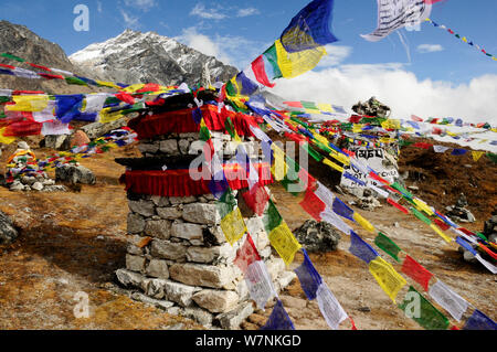 Prayer flags at memorial in Khumbu Valley, Sagarmatha National Park (World Heritage UNESCO). Khumbu / Everest Region, Nepal, Himalaya, October 2011. Stock Photo