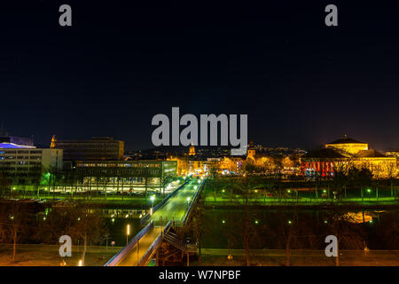 Germany, Bridge over saar river to old town of saarbrucken city in the night under sky full of stars Stock Photo