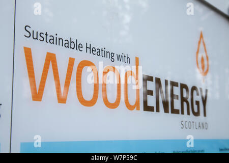 Sign for biomass heating using wood chips to generate heat. Scotland, UK, May. Stock Photo