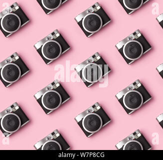 Seamless pattern with vintage instant camera at pastel pink background. Trendy film photo cam top view Stock Photo