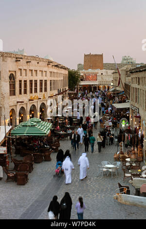 The restored Souq Waqif with mud rendered shops and exposed timber beams at dusk, Doha, Qatar, Arabian Peninsula 2011 Stock Photo