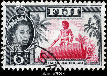 Man drumming on vintage fijian postage stamp Stock Photo
