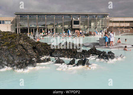 The Blue Lagoon, Iceland's most famous tourist attraction is located among the black lava flows outside Reykjavik. The geothermal spa owes its existence to the Svartsengi geothermal power plant powered by superheated seawater drawn from deep bore holes in the lava. The milky blue waters are rich in blue-green algae (cyanobacteria), mineral salts and fine silica mud. Reykjavik, Iceland 2006 Stock Photo