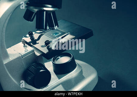Microscope Silver Color details of a silver microscope, with black background Stock Photo - Alamy