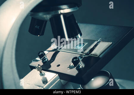 details of a silver microscope, with black background Stock Photo - Alamy