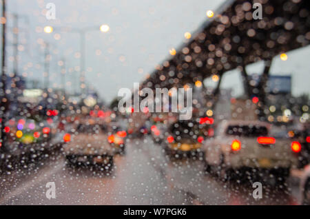 blur car on the road in traffic jam with raindrop Stock Photo