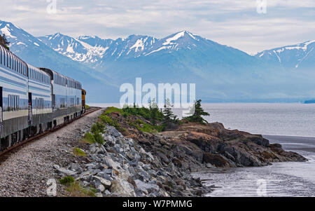 Turnagain Arm of Cook Inlet in Alaska from the Train showing the shoreline with mountains and glaciers in the background Stock Photo