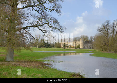Lacock Abbey, framed by English oak trees (Quercus robur) with grounds flooded by the River Avon bursting its banks after weeks of heavy rain, near Chippenham, Wiltshire, UK, January 2013. Stock Photo