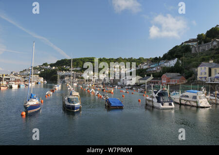 Sailing yachts, pleasure boats and fishing boats moored in Looe harbour, Cornwall, UK, June. Stock Photo