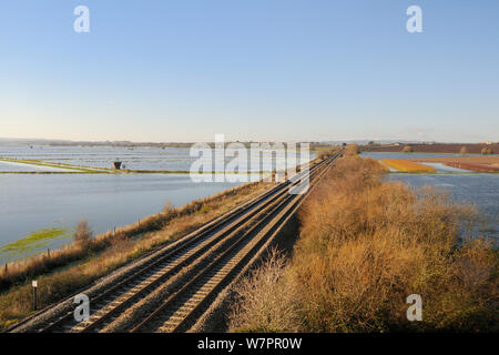 Railway line to Taunton crossing flooded West Sedgemoor, after weeks of heavy rain, Somerset Levels, UK, December 2012. Stock Photo