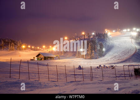 lluminated ski slopes at night, Ruka, Lapland, Finland Stock Photo