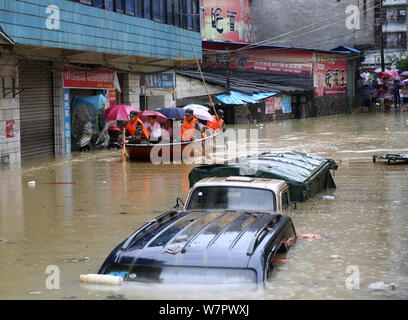 Chinese rescuers evacuate local residents by boat from flooded areas after heavy rain in Lutang village of Xiushui county, east China's Jiangxi provin Stock Photo