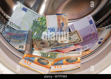 Cologne, Deutschland. 05th Aug, 2019. EURO, Swiss Franc and Dollar banknotes in a washing machine | usage worldwide Credit: dpa/Alamy Live News Stock Photo