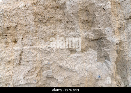 Sand wall of light sand with small pebbles as background Stock Photo