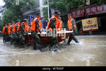 Chinese rescuers evacuate local residents by boat from flooded areas after heavy rain in Lutang village of Xiushui county, east China's Jiangxi provin Stock Photo