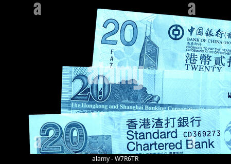 Different bills in twenty Hong Kong dollars close up. Money background blue color toned Stock Photo