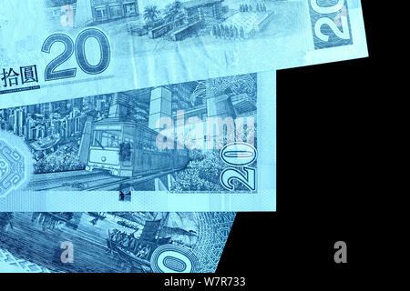 Different bills in twenty Hong Kong dollars close up. Money background blue color toned Stock Photo