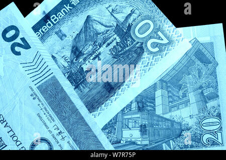 Different bills in twenty Hong Kong dollars close up. Money background blue color toned Stock Photo