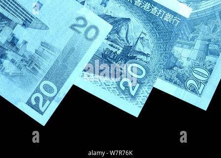 Different bills in twenty Hong Kong dollars close up. Money background blue color toned Stock Photo