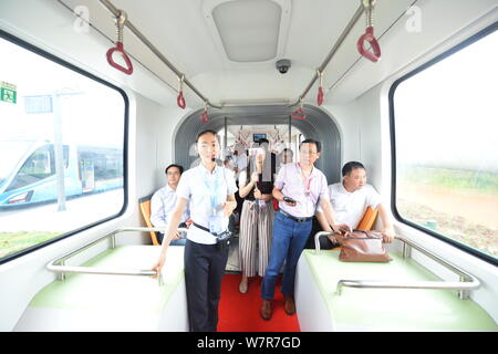 Visitors take the world's first railless train, developed by the CRRC Zhuzhou Institute Co. Ltd, in Zhuzhou city, central China's Hunan province, 2 Ju Stock Photo