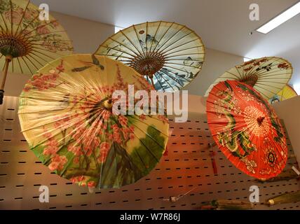 View of the oil paper umbrellas made by the seventh generation successor of Luzhou's oil paper umbrella Yu Wanlun at his studio in Hangzhou city, east Stock Photo