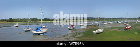 Panoramic view of Chichester Harbour, West Sussex, UK. Shows Chichester Channel near Dell Quay at low tide. Small boats moored, South Downs beyond. Stock Photo
