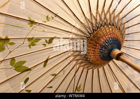 View of an oil paper umbrella made by the seventh generation successor of Luzhou's oil paper umbrella Yu Wanlun at his studio in Hangzhou city, east C Stock Photo