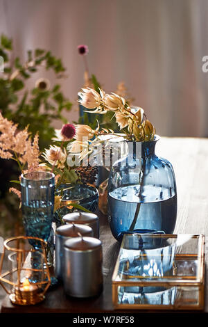 Decoration table newlyweds, blue dishes, bottles of flowers and candles.Wedding floristry. Stock Photo