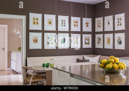 Lemons on kitchen counter by illustrations over dining area Stock Photo