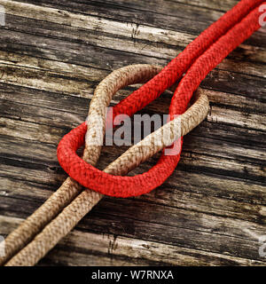 Tied ropes standing on wooden background. 3D illustration. Stock Photo