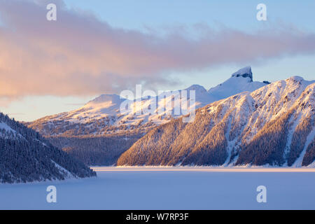 Soft evening light on a snowy landscape with the imposing Black Tusk above Garibaldi Lake in Garibaldi Provincial Park. British Columbia. March 2013 Stock Photo