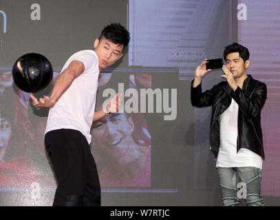 Taiwanese singer Jay Chou, right, takes photos at a promotional event for Sony Xperia smartphone in Taipei, Taiwan, 17 May 2017. Stock Photo