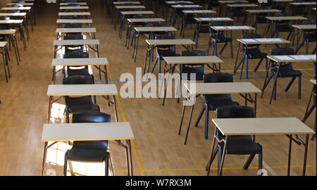 various views of an exam examination room or hall set up ready for students to sit test. multiple desks tables and chairs. Education, school, student Stock Photo